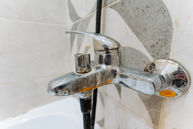 Hard water scale and mineral buildup on a chrome bathroom faucet in a San Diego home