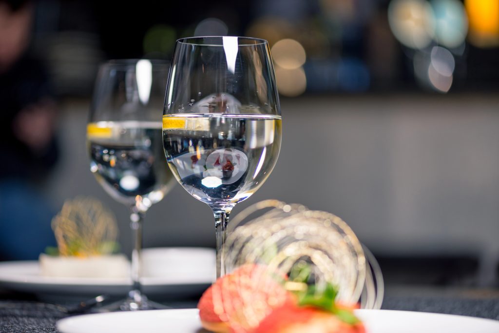 Two glasses of clear water demonstrating the benefits of alkaline water vs reverse osmosis.